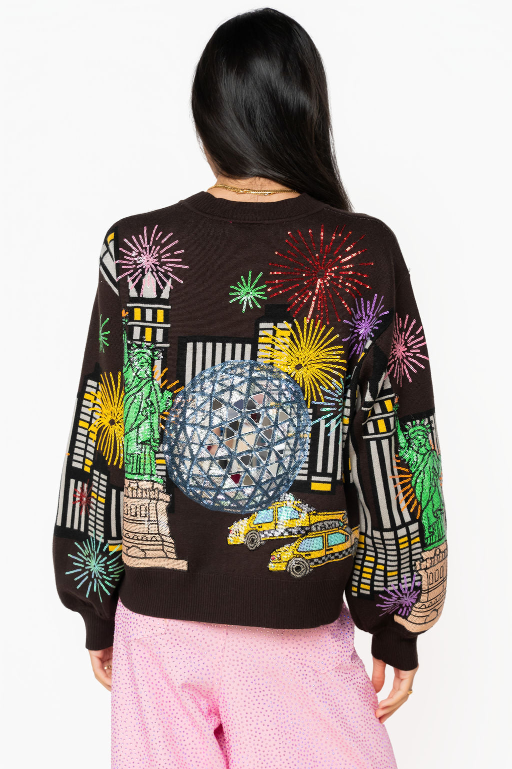 Back view of black Queen of Sparkles New Year's Eve cardigan with embellished New York City details, fireworks, taxis, and Statue of Liberty.