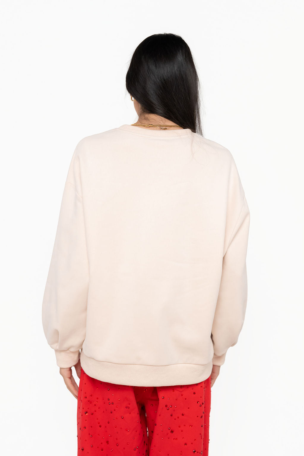 Model wearing back view of cream Queen of Sparkles Monica turkey-head sweatshirt.