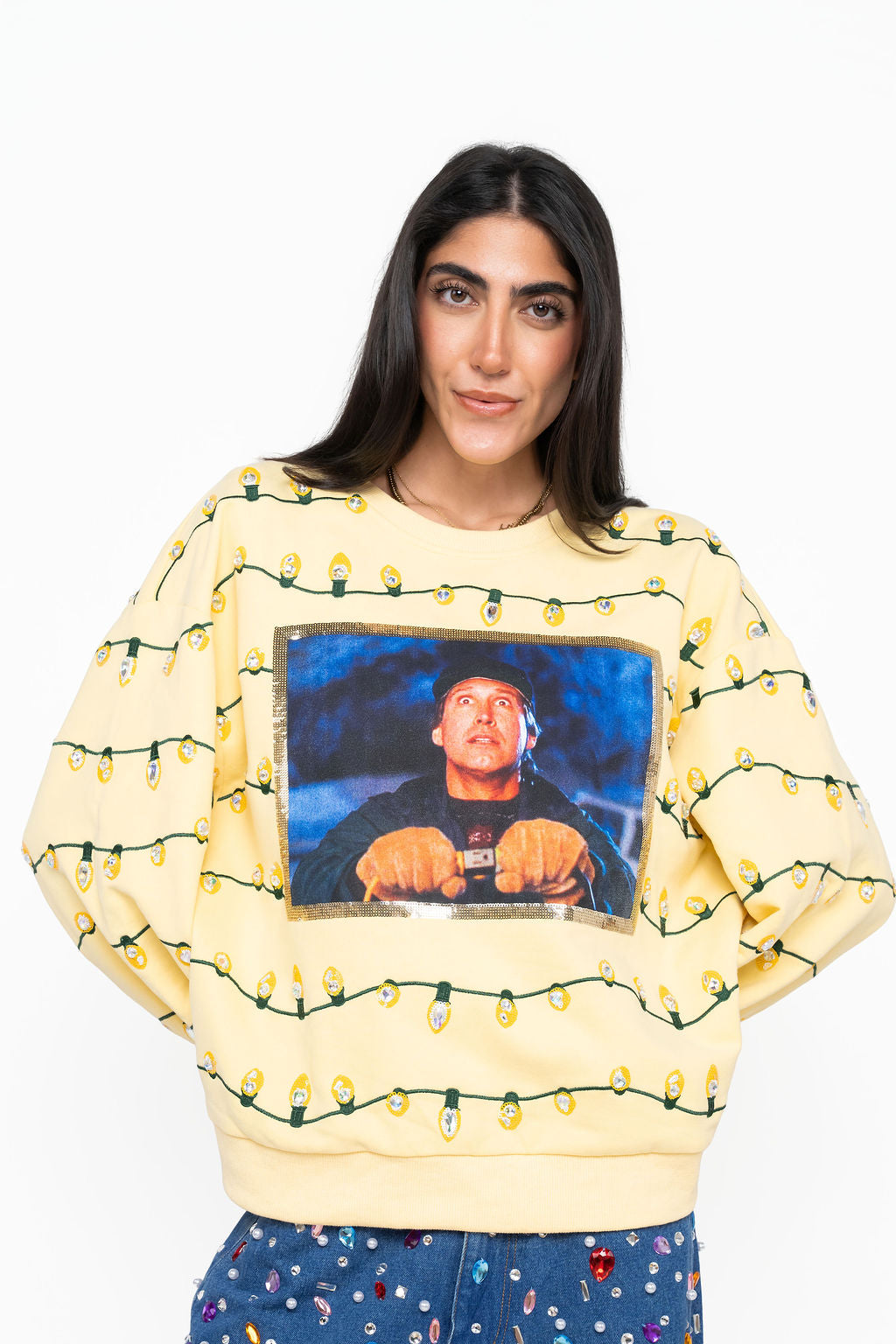 Queen of Sparkles yellow sweater with a Clark Griswold screen print framed in sequins and rows of sequin Christmas string lights.