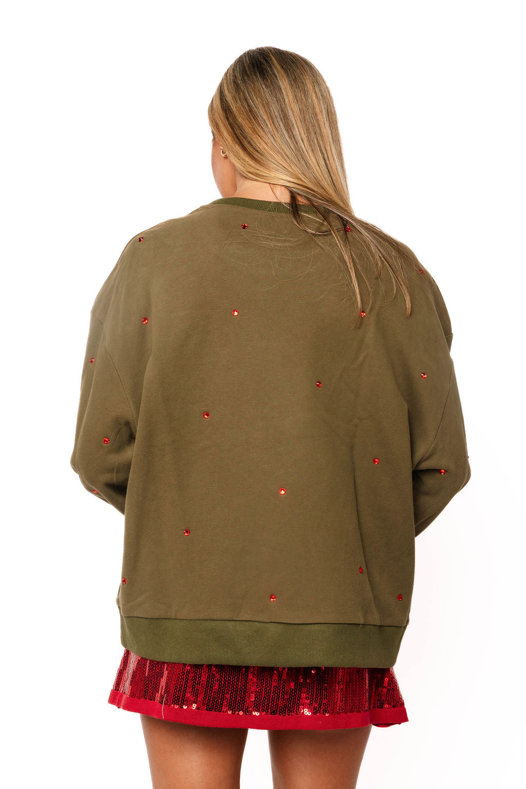 Model back view wearing a Queen of Sparkles olive green sweatshirt with red embellishments.