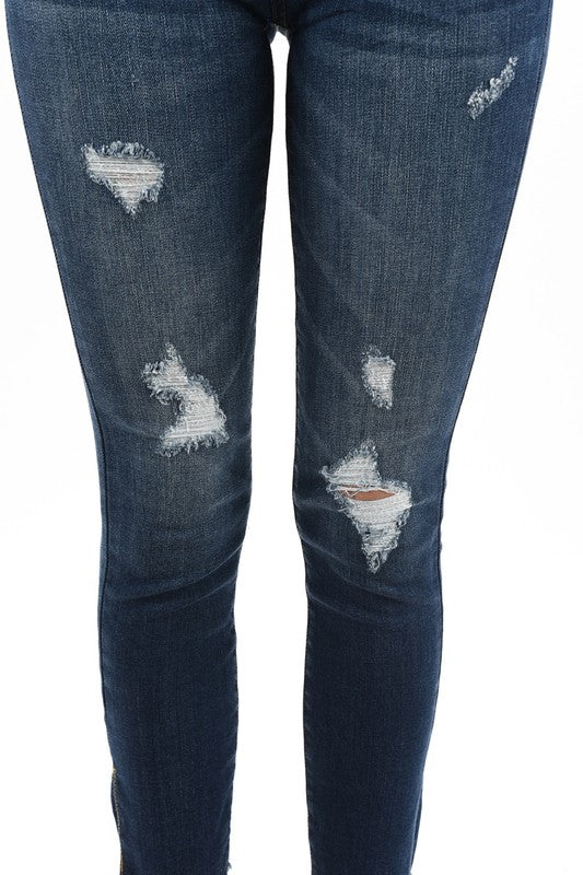 dark blue distressed denim with side slit and raw hem springtime stretch jean