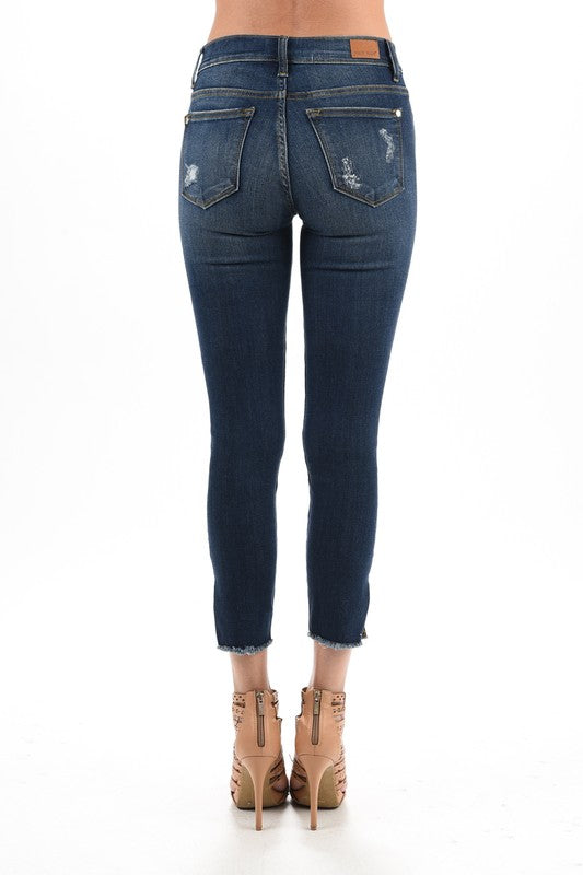 dark blue distressed denim with side slit and raw hem springtime stretch jean