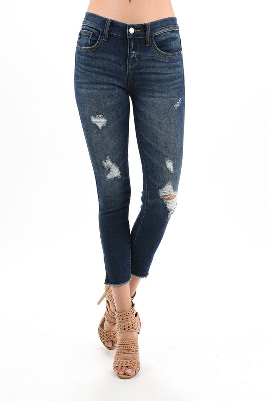 dark blue distressed denim with side slit and raw hem springtime stretch jean