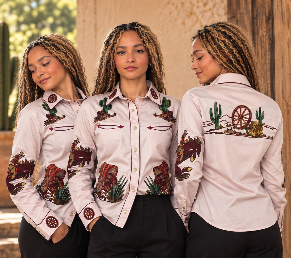 Three views of the dusty-pink western shirt showing cactus and arrow embroidery in front and a wagon-wheel desert scene on the back.