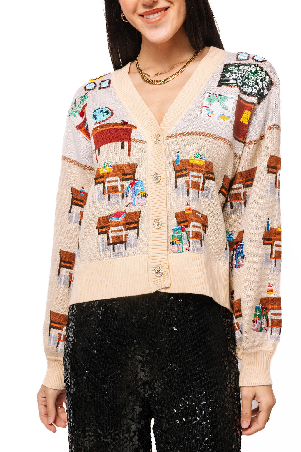 Front view of a beige Queen of Sparkles cardigan with multicolor classroom and school-themed scenes across the front.
