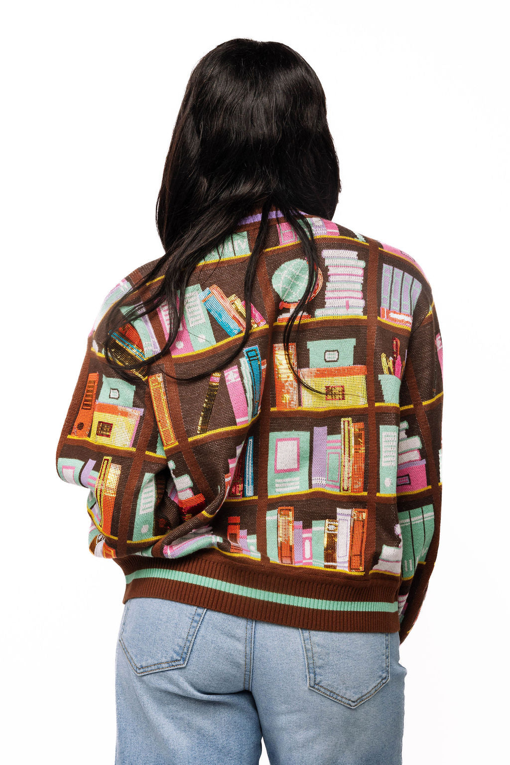 Back view of brown Queen of Sparkles cardigan with colorful library bookshelf design