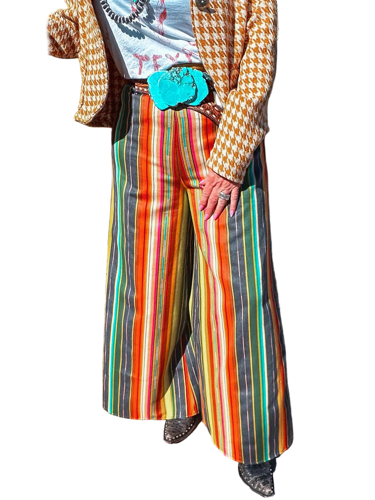 Front view of wide-leg Desert Sun serape trousers with orange, black, yellow and green vertical stripes