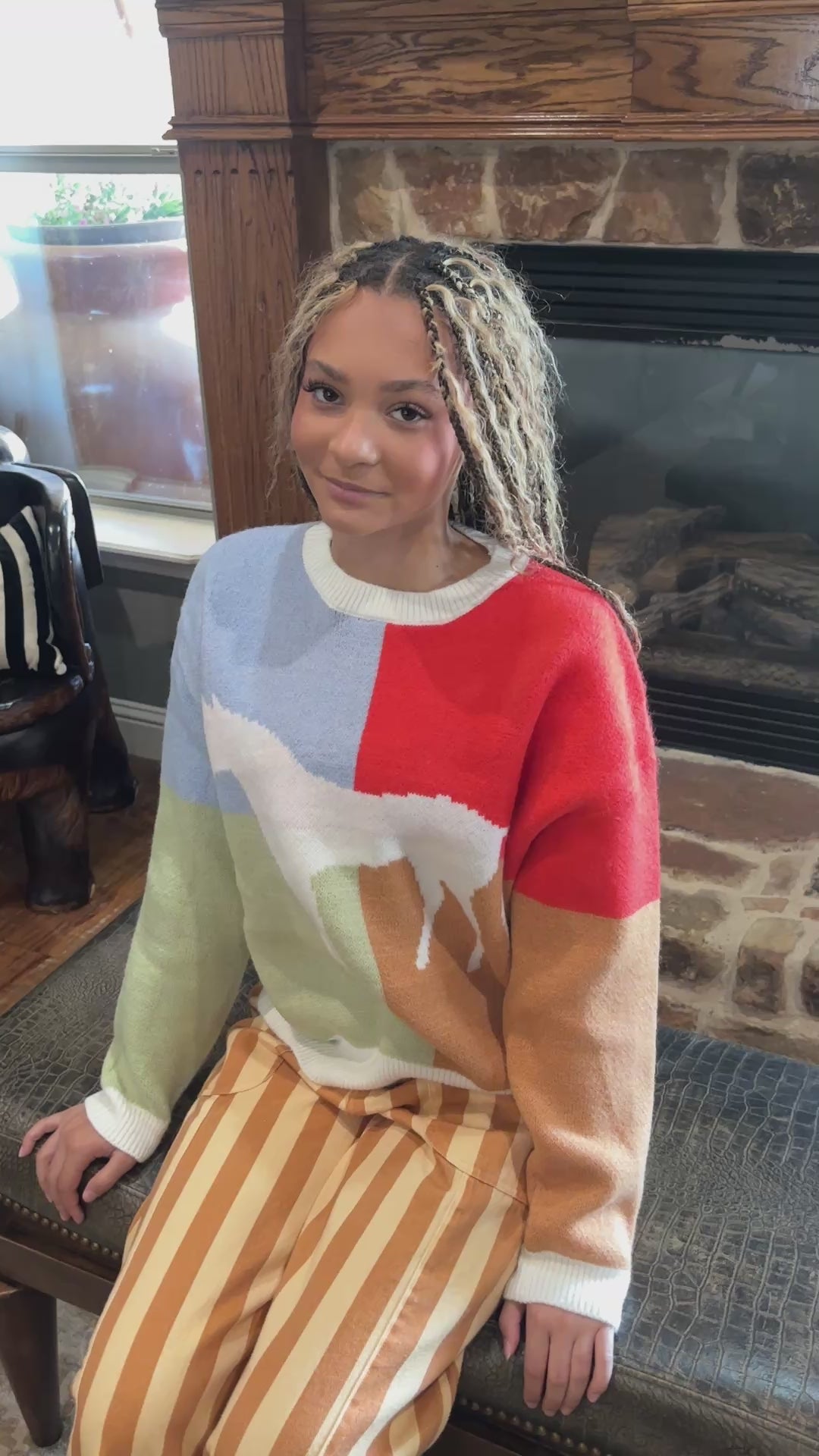Model shows the pastel colorblock western horse sweater in a short product video