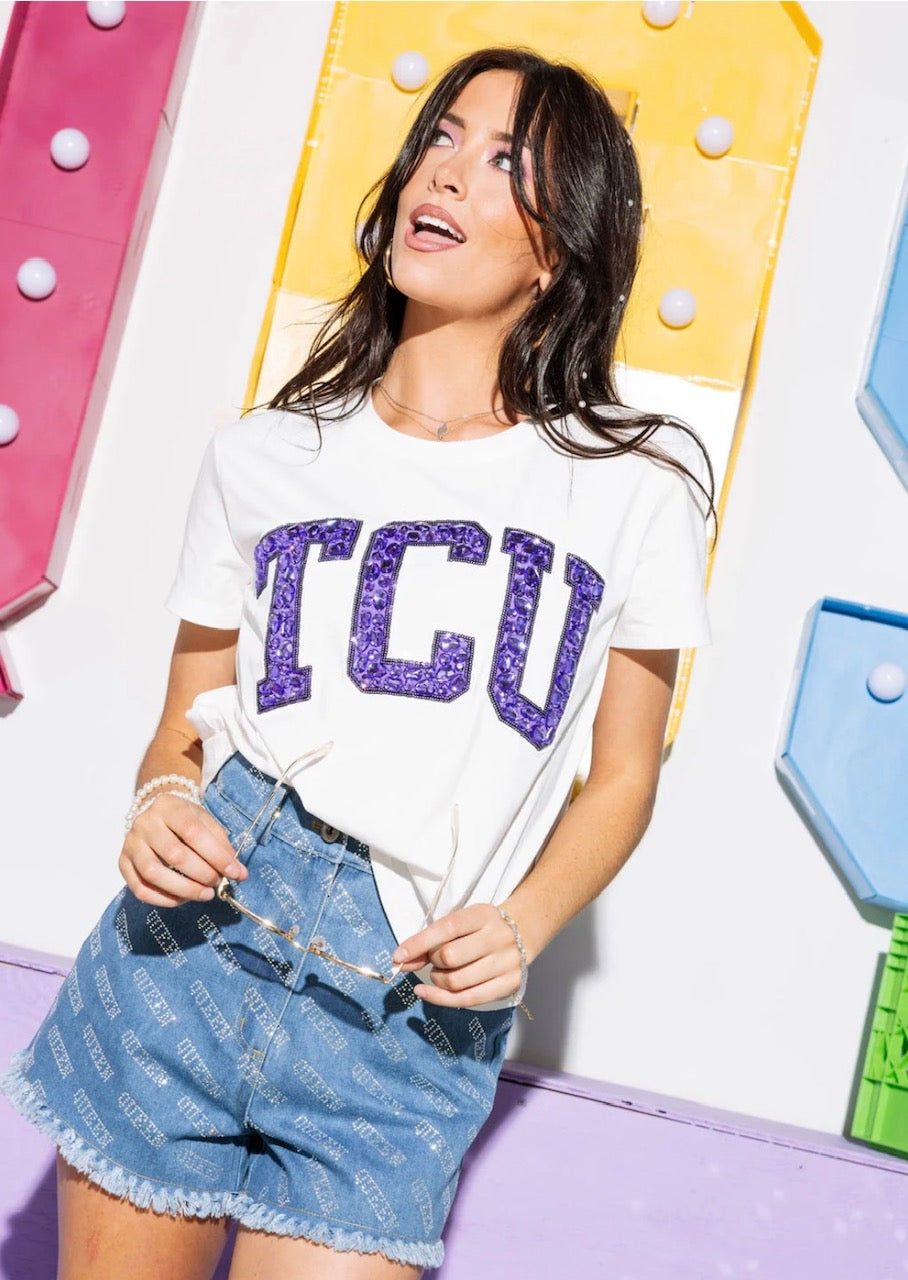 Angled model view of white TCU tee with purple jeweled lettering