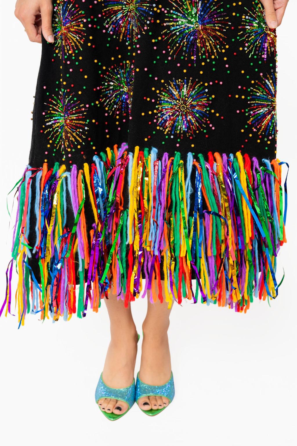 Close-up of multicolored firework inspired fringe details on Queen of Sparkles black knit dress