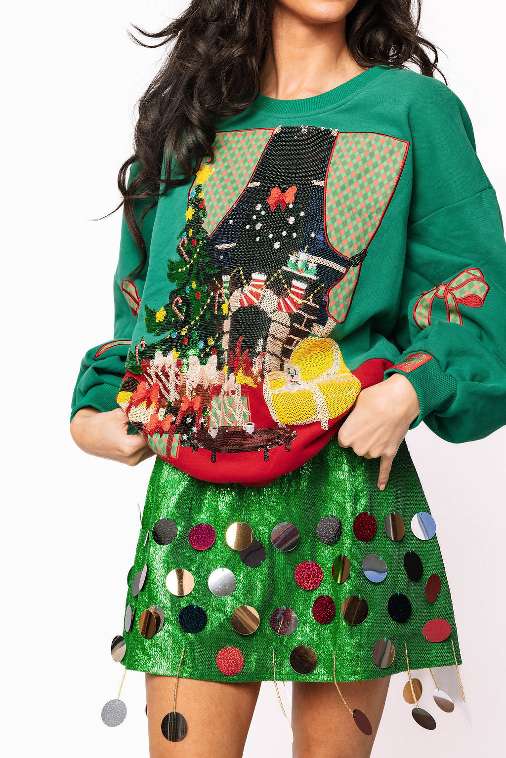 Queen of Sparkles green Christmas living room sweatshirt with bow sleeves product image.