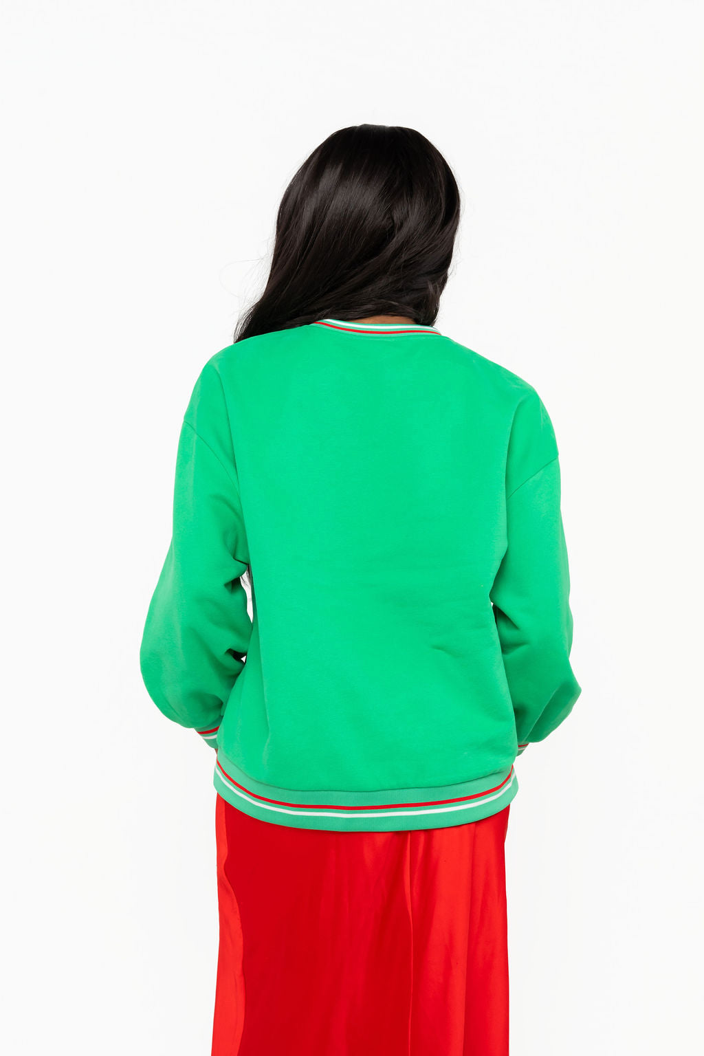 Back view of Queen of Sparkles green Christmas sweatshirt with a plain back and red and white striped neckline, cuffs, and hem.