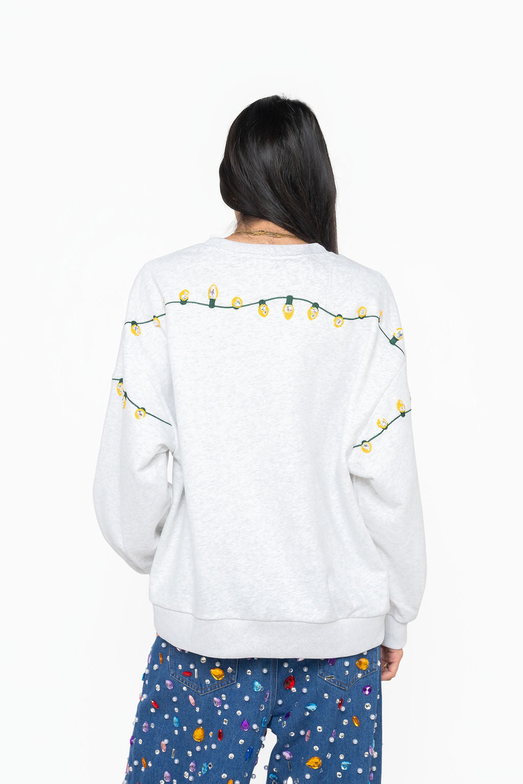 Back view of Queen of Sparkles gray Cousin Eddie sweatshirt with yellow Christmas lights across the shoulders and sleeves.