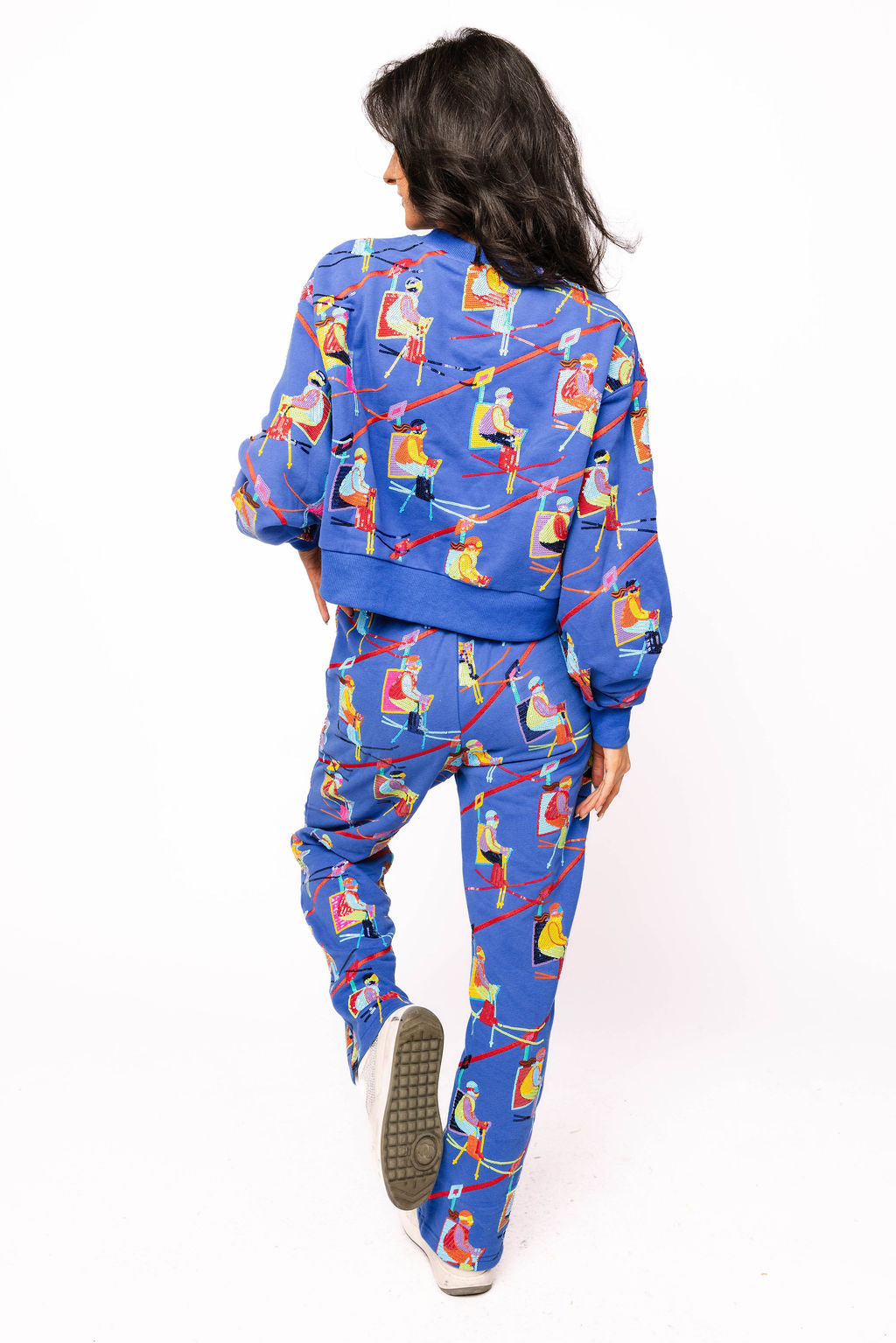 Back view of the model wearing the Queen of Sparkles royal blue ski-lift sweatshirt with matching joggers.