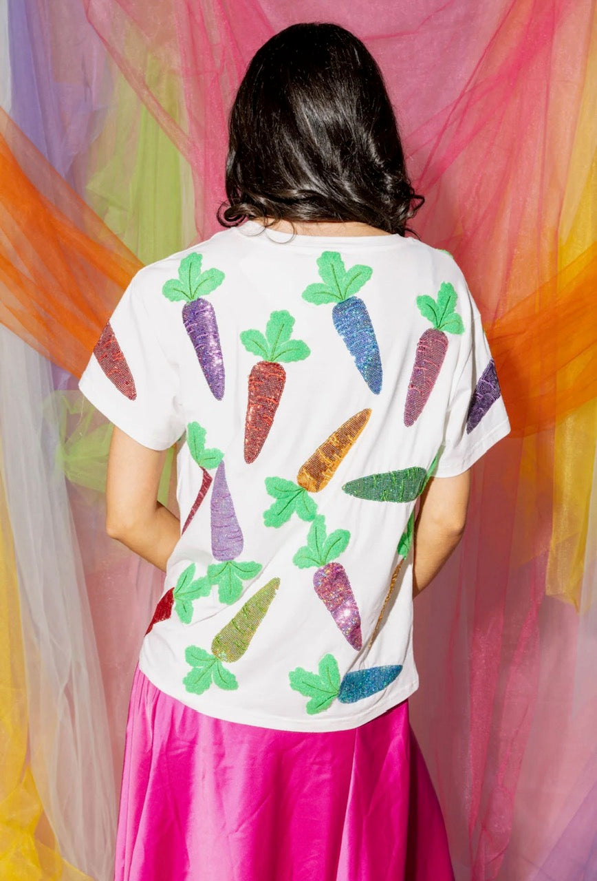 Back view of a model wearing the Queen of Sparkles white short-sleeve tee with colorful sequined carrot motifs across the back.