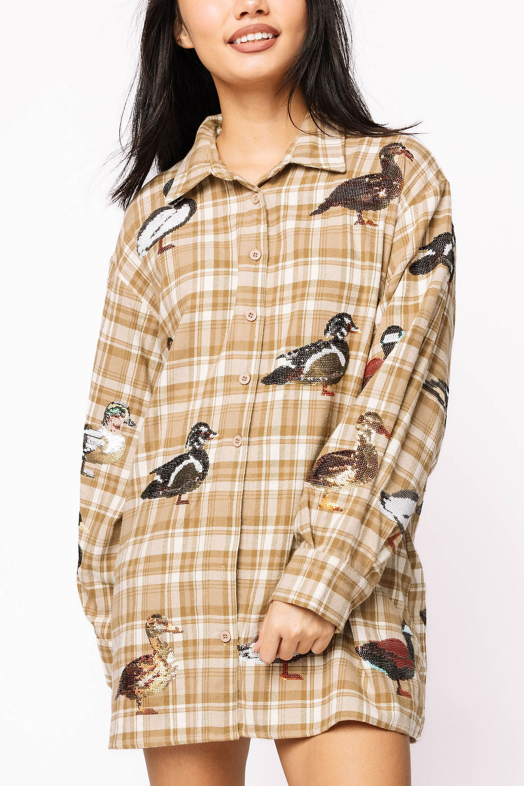 Front view of a model wearing the Queen of Sparkles brown plaid button-up dress with sequin duck embellishments.