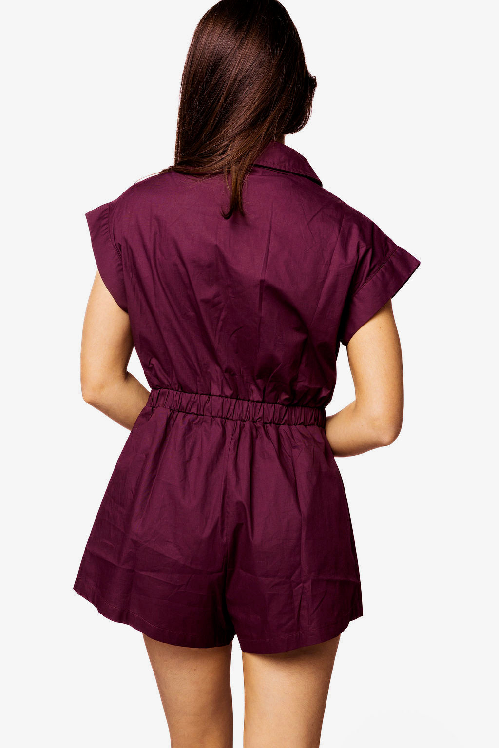 Model shown from behind wearing a maroon Queen of Sparkles Texas A&M romper, with short sleeves, a collar, elastic waist, and shorts.