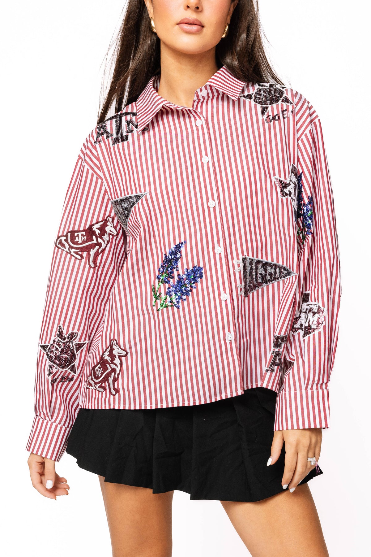 Front view of a model wearing a red-and-white striped Queen of Sparkles Texas A&M button-down with scattered Aggies icons.