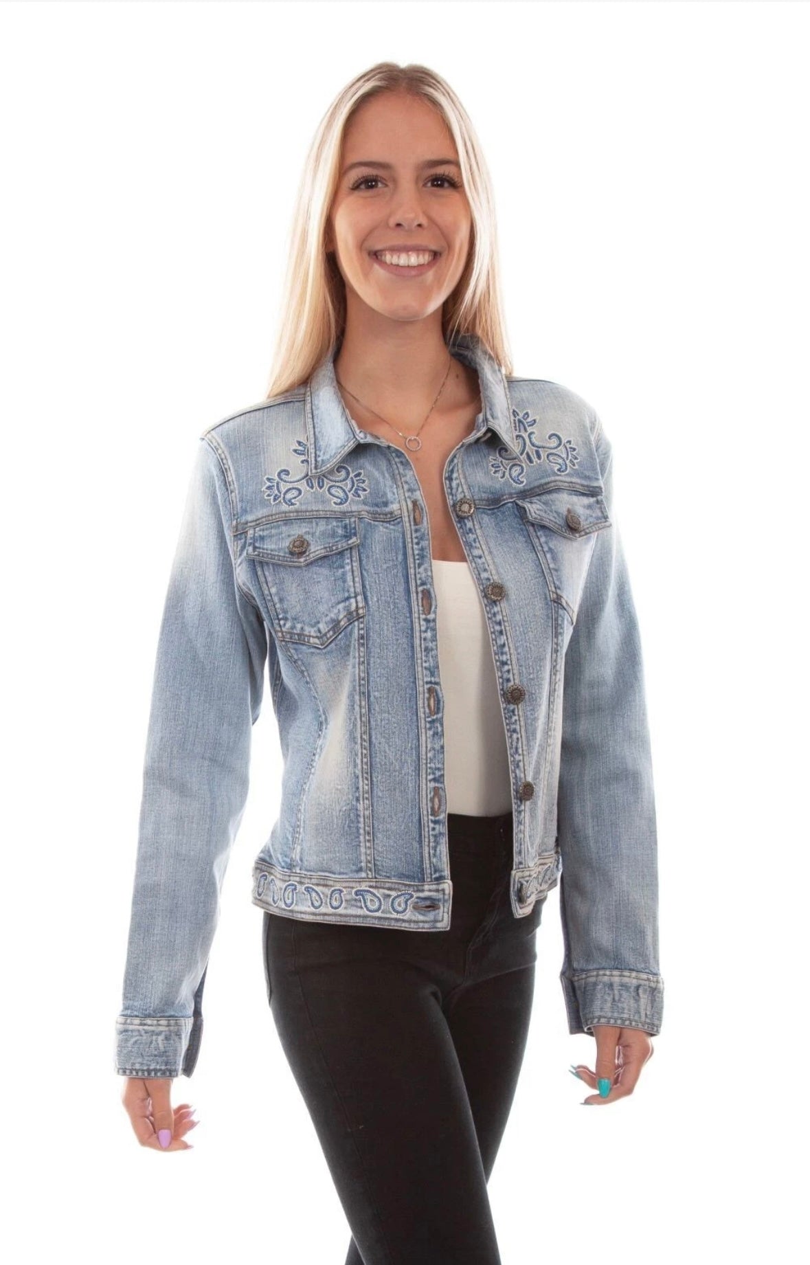 Front view of a model wearing the Scully light-wash denim jacket with decorative motifs near the shoulders and hem.