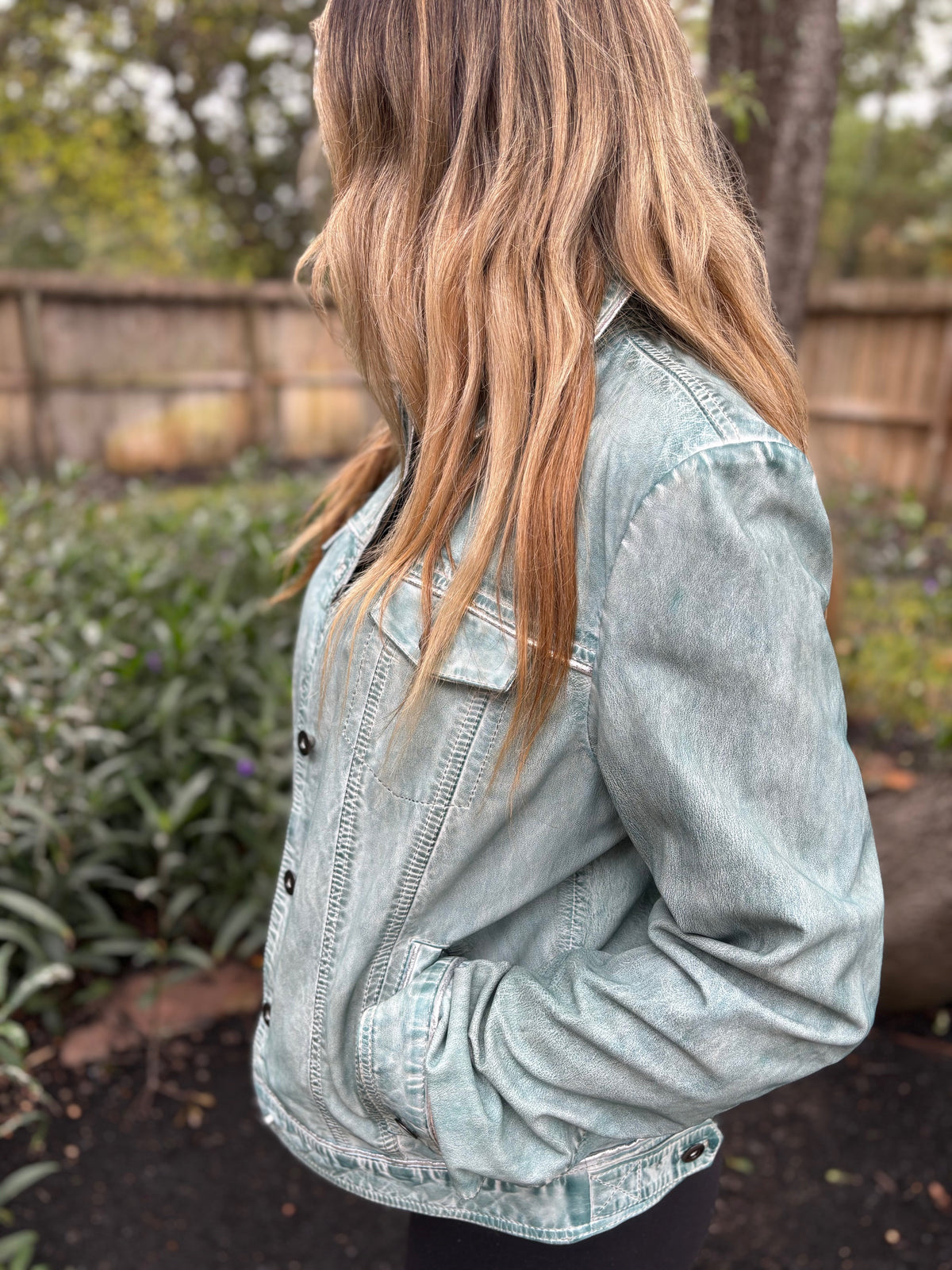 Side view of the Scully pale-blue distressed leather jacket on a model, showing the front buttons, chest pocket and side pocket.