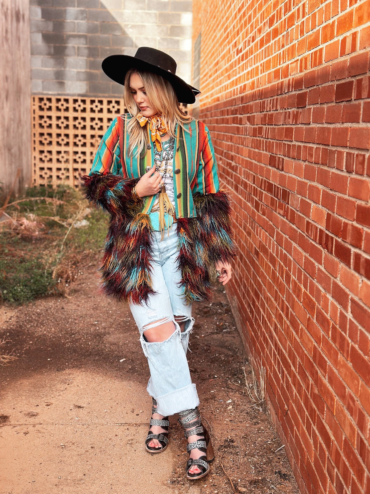Model wearing Silverado Apparel Tess Sundance Multi Llama Western jacket with distressed jeans and black cowboy hat