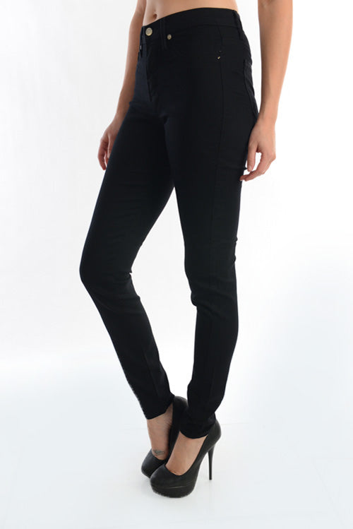 Angled view of Judy Blue black high-waist skinny jeans on a model, showing the slim leg profile.