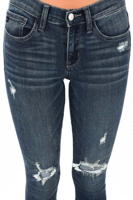 Close-up of the dark-wash Judy Blue jeans showing distressed details at the thigh and knees.